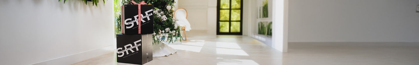 SRF Boxes in front of a Christmas tree with a holiday bow