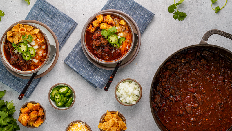 SRF Ground Beef Texas Chili in a cast iron pot and bowls