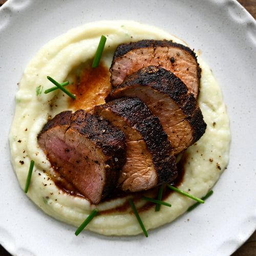 Sliced roasted beef on a white plate