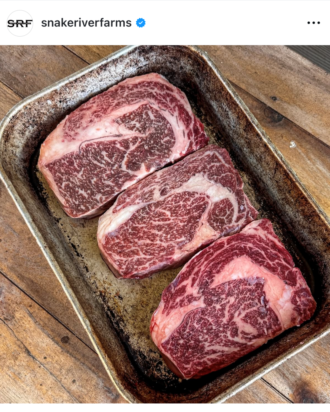 Instagram post of a pan with a few ribeye steaks