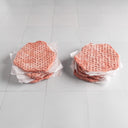 Two stacks of smash burger patties on a white tiled surface