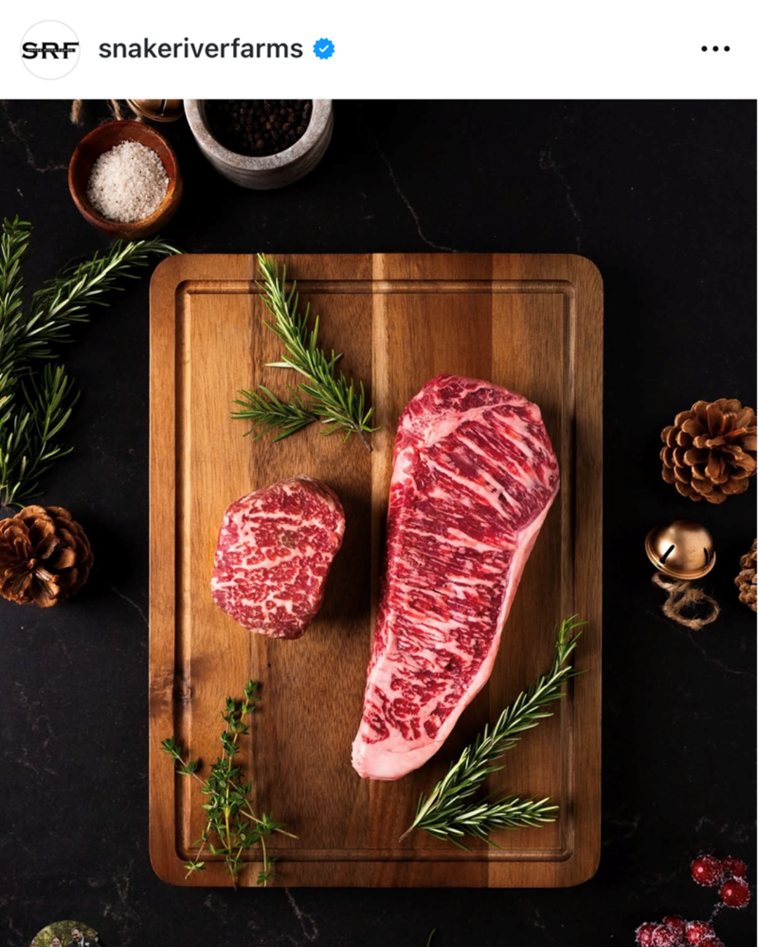 Instagram post with two raw steaks on a cutting board with rosemary and other holiday items