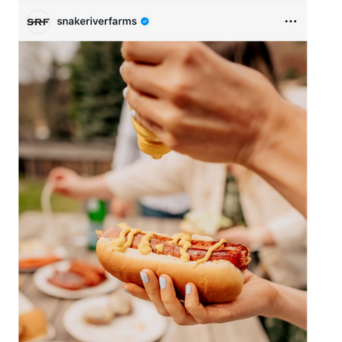 UGC Screenshot of hot dog with person putting mustard on it