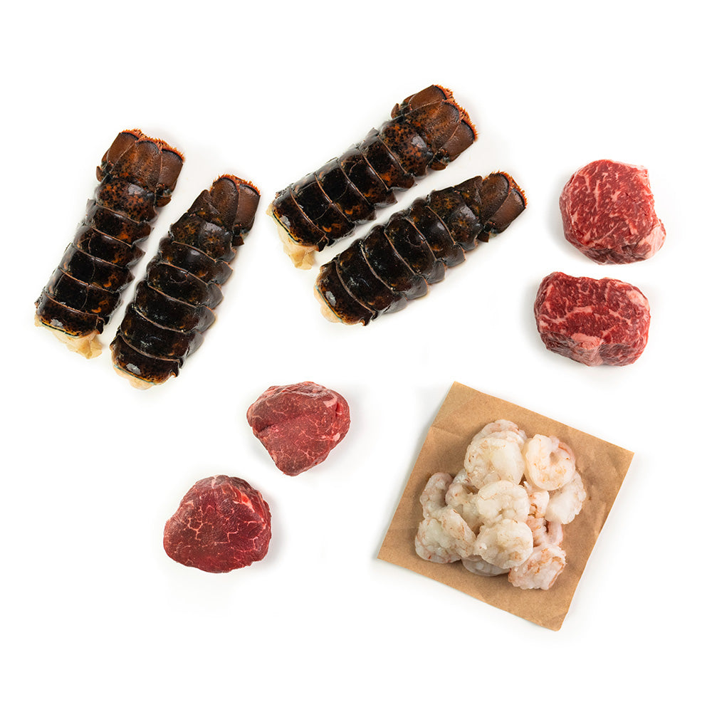 An assortment of fresh steak and seafood products, including filet mignon, ribeye, lobster, and shrimp, laid out on a white background.