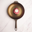 raw filet mignon with chef's gold in cast iron skillet 