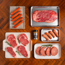 Assorted raw meats on a wooden surface with SRF seasoning.