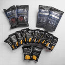 Multiple packages of Snake River Farms branded snacks on a white tiled background