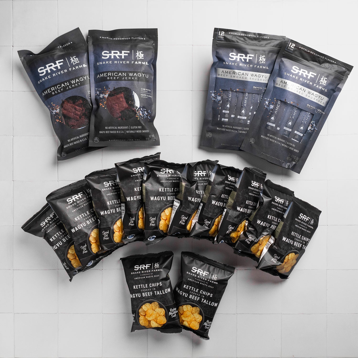 Multiple packages of Snake River Farms branded snacks on a white tiled background