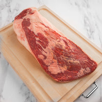 raw USDA choice brisket on cutting board 