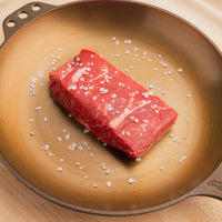 USDA Choice Flank Steak with finishing salt in cast iron pan 