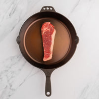 USDA Choice NY Strip Steak in skillet 