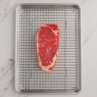 USDA Choice Boneless Strip Steak 14 oz. on a rack and pan |Choice|14 oz.|18 oz.