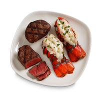 Cooked lobster and steak on a plate 