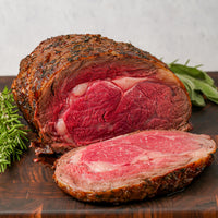 cooked prime rib beef roast on cutting board