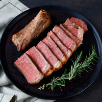 Plated sliced Delmonico Steak with Rosemary 