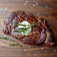 Cooked ribeye steak with butter and thyme |lifestyle