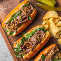 Cooked NY strip slices sandwiches on cutting board  