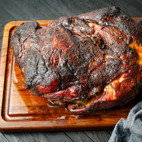 smoked pork shoulder on cutting board 