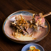 cooked cap of ribeye in bowl with chopsticks