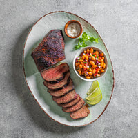 cooked Tri-Tip steak plated with beans 