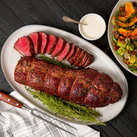 cooked tenderloin roast sliced with sides 