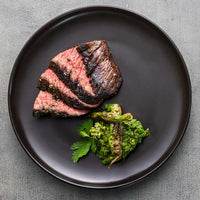 sliced and cooked Zabuton steak plated with chimichurri 