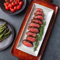 Cooked and sliced Tere Major on plate with rosemary sprig