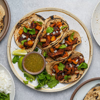 Pork Collar tacos on a plate with salsa 