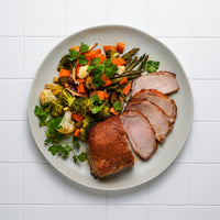 Cooked and sliced pork loin roast on a plate 