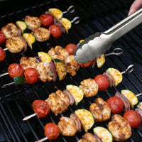 Shrimp on skewers on grill with veggies