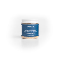 Jar of cherrywood smoked salt, pepper, and garlic seasoning on a white background