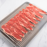 Raw NY Strip Slices on a rack 