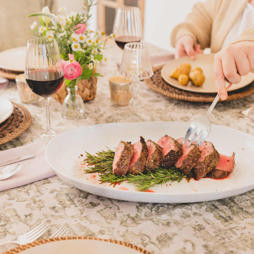 Sliced Tenderloin Roast with a fork on and Easter Table 