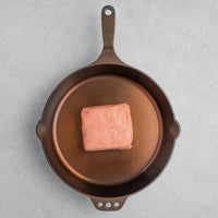 Raw ground Kurobuta pork in cast iron skillet 