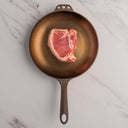 Pork Porterhouse in cast iron skillet 