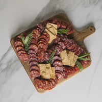 Charcuterie Board with salami and crackers on cutting board 