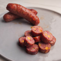 Cooked Jalapeno cheddar sausage sliced on plate 