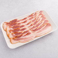 raw Apple Brined Bacon on a plate 