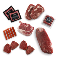 Assorted cuts of raw meat including steaks, sausages, and packages on a white background.