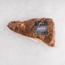 Packaged Wagyu Smoked Tri-Tip on a white background with a visible label detailing the product type and brand.
