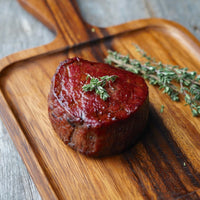 USDA Prime Boneless Filet Mignon cooked n cutting board with Thyme 