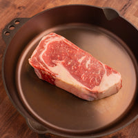 USDA Prime ribeye steak 1.5" raw in cast iron 