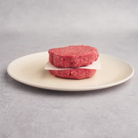 stacked raw dry-ages patties on plate