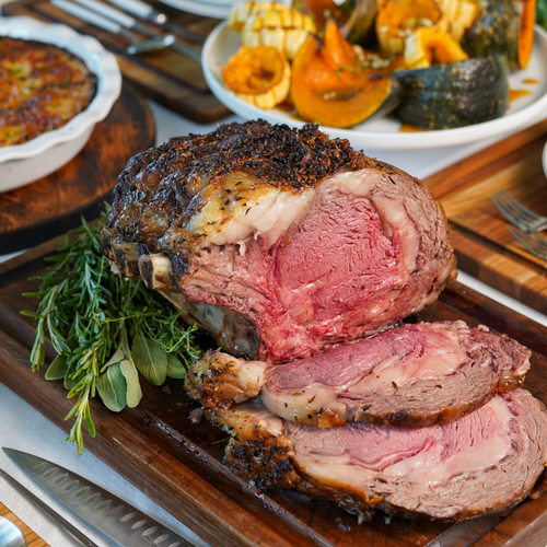Cooked and sliced Bone-in Prime Rib on table with Holiday sides