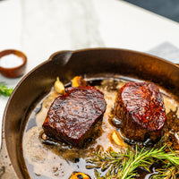 two ribeye filet in cast iron skillet 