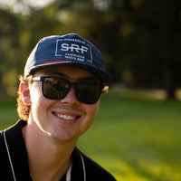 guy in sunglasses wearing blue SRF hat 