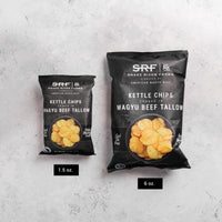 Two packages of Snake River Farms kettle chips on a gray background