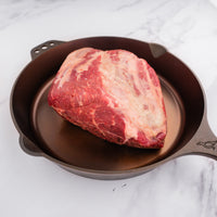 raw chuck roast in cast iron skillet 