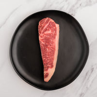 SRF Black® NY strip steak raw on black plate |SRF Black®|1"|1.5"