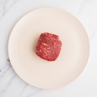 raw SRF Black® ribeye filet on white plate 